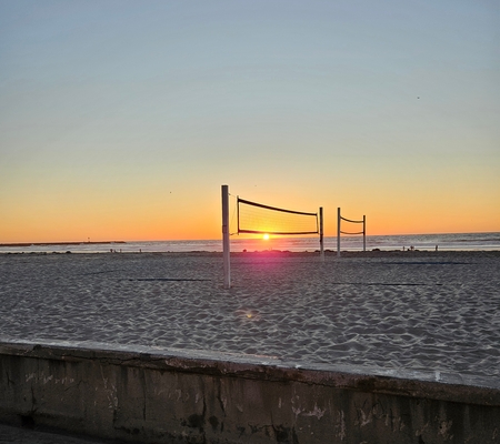 Sunset behind volleyball net at Mission Beach